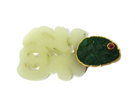A gold mounted carved jade pendant, the shaped oval top carved in an Oriental design and mounted with a cabochon ruby, the bo