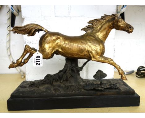 A gilt bronze model of a galloping stallion, late 19th century, raised on a naturalistic cast base and black marble rectangul