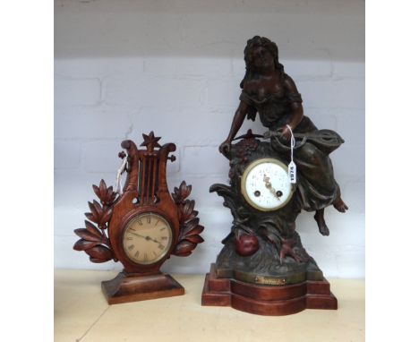 A patinated spelter mantel clock, early 20th century, surmounted with a classical maiden playing a mandolin, centred with a f
