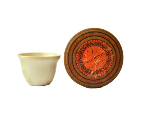 A Victorian  whiteware needlecase with paper label printed "A Brighton Trifle" enclosing a white ceramic thimble, 3cm, and a 