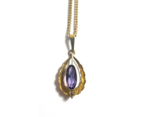A 9ct gold and amethyst set single stone pendant, mounted with a marquise shaped amethyst within a textured openwork surround