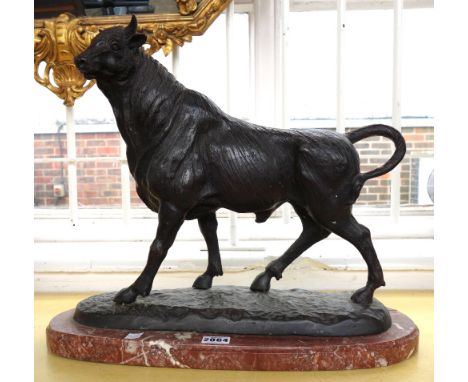 After Barye, a bronze figure of a bull on an oval marble base, 39cm high.