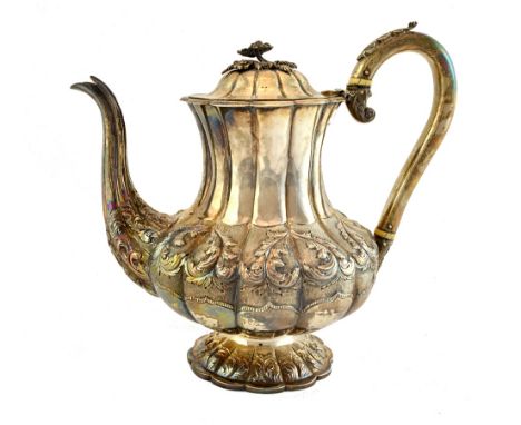 A William IV silver coffee pot, of melon fluted form, with scroll embossed and engraved decoration, on a shaped circular foot