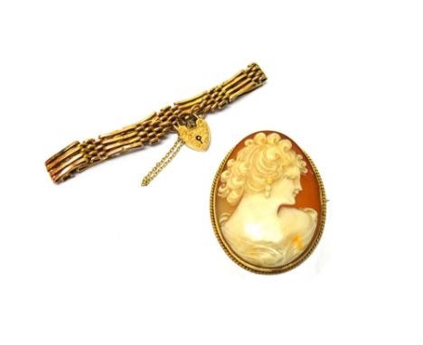 A gold mounted oval shell cameo brooch, carved as the portrait of a lady, within a ropetwist wirework surround, detailed 9 CT