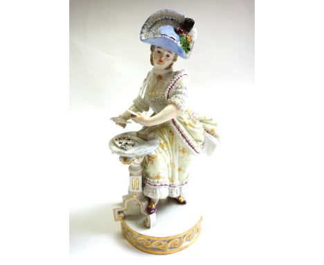 A Meissen porcelain figure, 19th century, modelled as a  lady in a yellow dress, after the model by Acier, standing at a tabl