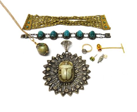 A filigree pendant, mounted with a ceramic scarab at the centre, a bracelet mounted with a row of pale blue oval ceramic scar