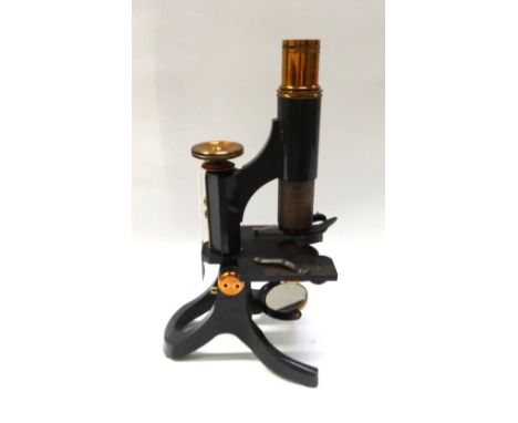 A Swift & Son ebonised brass microscope, early 20th century, in a fitted mahogany case, with spare eye pieces and objectives.