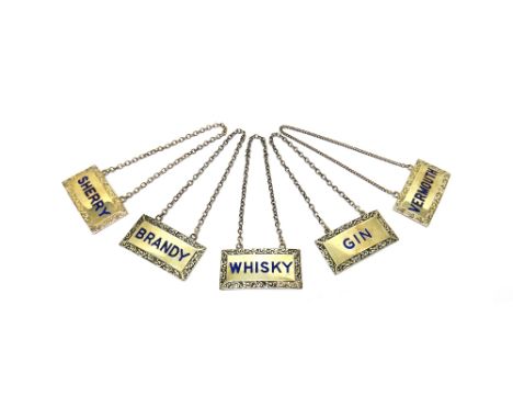 A set of five silver and blue enamelled decanter labels, comprising; Sherry, Brandy, Gin, Whisky and Vermouth, each of curved