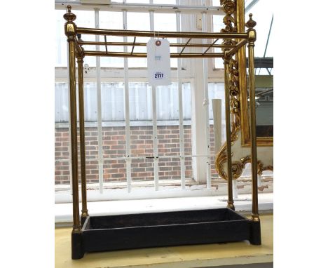 An Edwardian tubular brass twelve division stick stand of rectangular form, with turned finials and a cast iron tray, 62cm hi