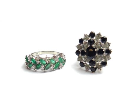 A white gold, emerald and diamond set half hoop ring, mounted with a row of marquise shaped emeralds, interspersed with circu