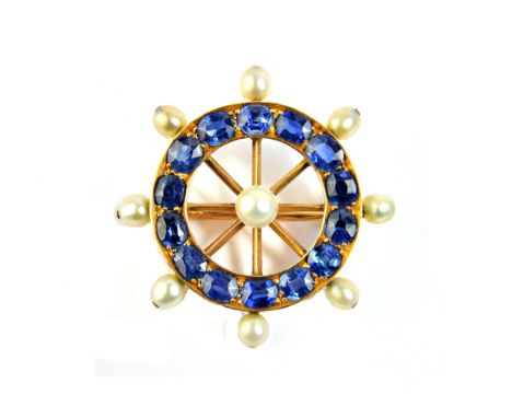 A gold, sapphire and cultured pearl brooch, designed as a ship's wheel, mounted with the principal cultured pearl at the cent