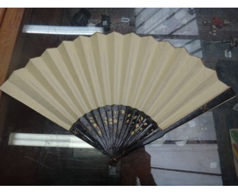 A Continental mother of pearl and painted paper fan, 19th century, with foliate engraved sticks and a painted paper fan depic