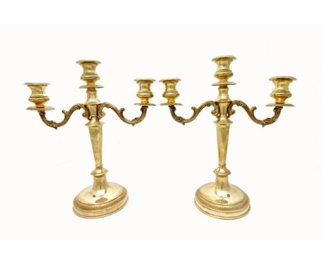 A pair of Greek silver three light candelabra by Lalaounis, each with scrolling arms, decorated rims and on a decorated circu