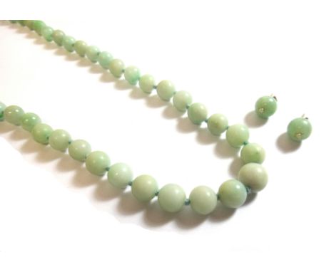 A single row necklace of graduated jade beads, on a gold clasp, detailed 9 CT and a pair of jade and imitation seed pearl ear