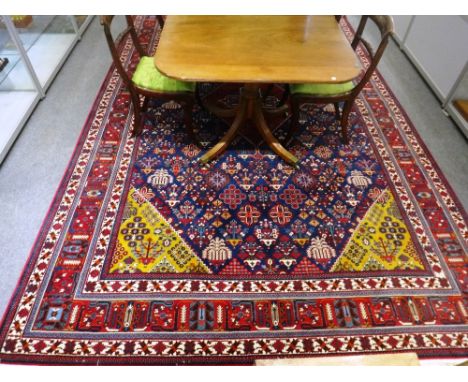 An Isfahan carpet, Persian, the indigo field with a bold madder diamond, sage spandrels, all with diamond floral patterns, a 