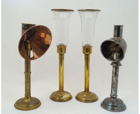 A group of four spring-loaded candlesticks, to include a late Victorian brass student's candlestick with copper reflector hoo
