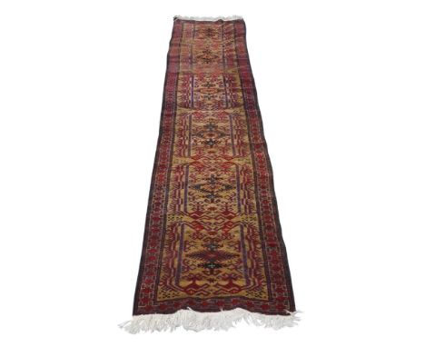 An Afghan Belouch runner, 20th century, repeating geometric motifs, on a beige ground, contained by red ground geometric bord