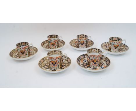 Six Derby Imari coffee cans and saucers, 19th century, with floral and foliate decoration with gilt detailing, having red cro