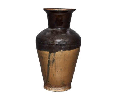 A Chinese stoneware brown-glazed vase, Ming dynasty, the top half covered in a thick dark brown glaze stopping mid way to a l