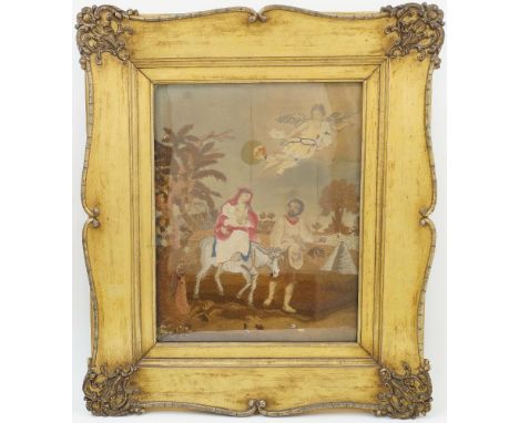 Two framed silk embroidered pictures, 19th century, one depicting The Flight into Egypt, with Joseph leading Mary and the inf