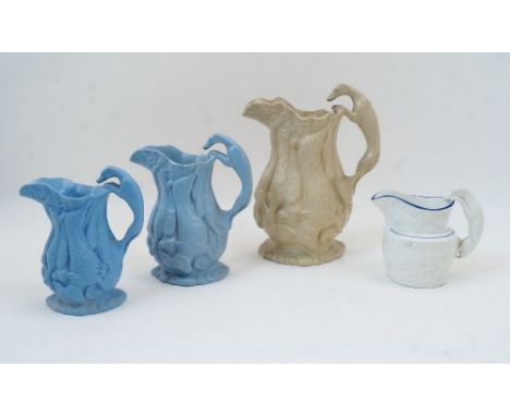 Three relief moulded jugs, each with a continuous frieze of game, the handles in the form of greyhounds, comprising: the larg