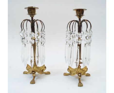 A pair of Regency style brass candlestick lustres with facetted glass drops, first half 20th century, the drops suspended on 