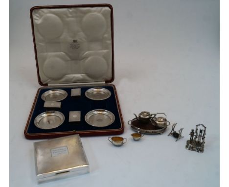 A cased set of four silver ashtrays and three matchbox covers, one matchbox cover missing, London, 1929, William Comyns & Son