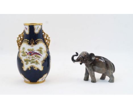 A Worcester style porcelain cobalt blue ground vase, late 19th century, with pierced twin handles and gilt highlights, decora