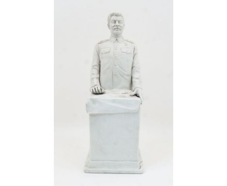 Russian Interest: A bisque ceramic sculpture of Stalin standing at a podium, 20th century, 43cm highPlease refer to departmen