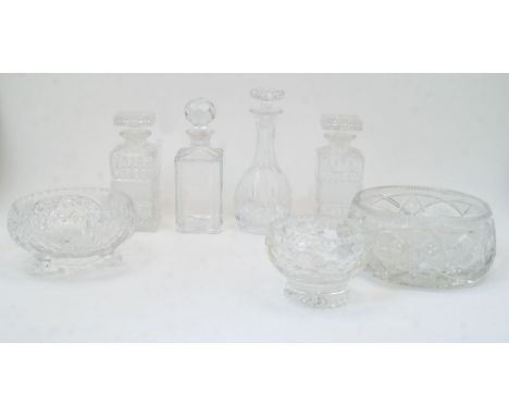 A group of cut glass bowls and decanters, 20th century, to include: a bulb shaped decanter with elongated neck and flat base,