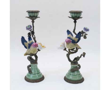 A pair of Continental gilt metal and porcelain candlesticks, with gilt metal stems in the form of a branch with ceramic perch
