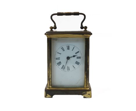 A French brass carriage timepiece, the corniche case with swing handle and bevelled glass panels, the white enamel dial with 
