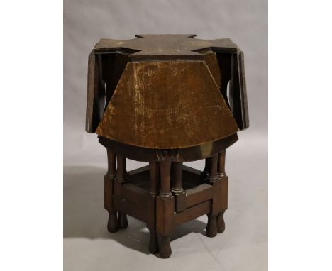 An unusual oak gate leg table, early 20th century, with eight drop leaves to form a circular table, 77cm high, 112cm diameter