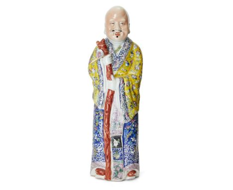 A large Chinese famille rose figure of Shoulao, Republic period, modelled standing holding his staff with peach finial, weari