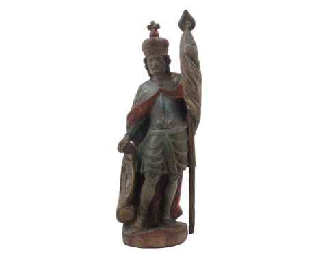 A Northern European polychrome painted figure, late 19th / early 20th century, wearing a crown and cloak and holding a flag i