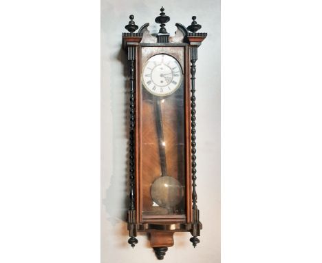 A mahogany and ebonised Vienna regulator style wall clock, 20th century, with broken arched pediment and knopped finials, the