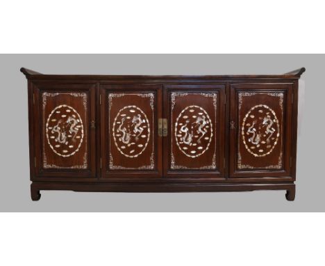 A Chinese hardwood sideboard, 20th century, with mother of pearl inlay, decorated with dragons, flora and fauna, the two cent