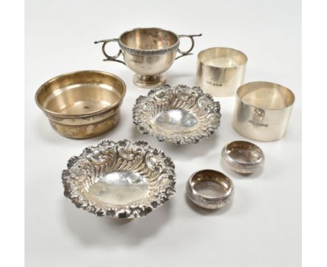 A collection of silver dishes and napkin rings. To include a pair of hallmarked silver napkin rings hallmarked for Birmingham