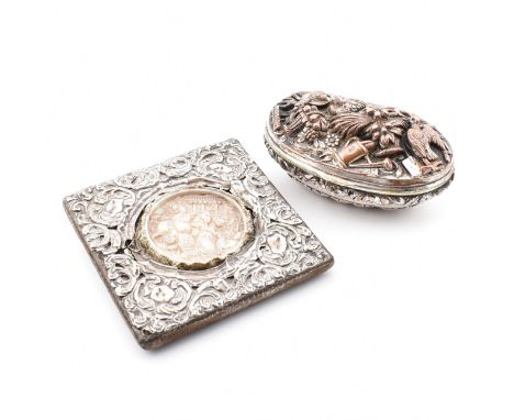 A hallmarked silver mounted frame with velvet surround. The frame encasing a carved central panel depicting scenes of battle.