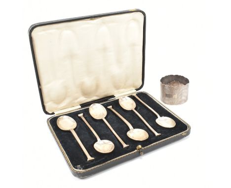 A hallmarked silver cased set of six tea spoons and a napkin ring. The hallmarked silver tea spoons with original velvet line