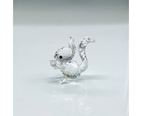 Clear faceted crystal figure of a squirrel holding a crystal. Part of the Woodland Friends collection. Swarovski mark. This i
