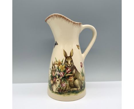 A cream-colored pitcher decorated with charming rabbits, flower baskets, and butterflies, featuring a slender neck. Dimension