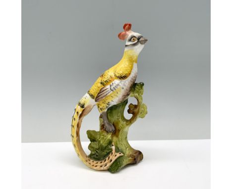 A majestic yellow bird with a long tail and a red crown perched atop the branches of a tree trunk, keeping watch. Dimensions: