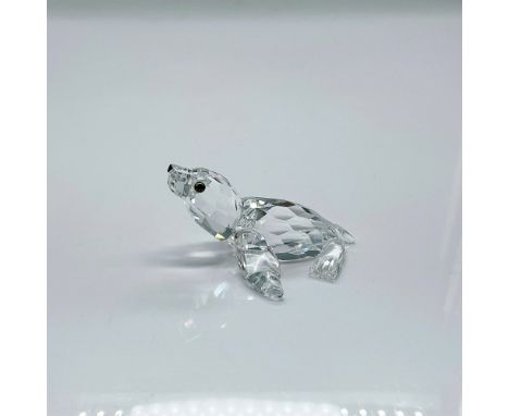 Clear faceted crystal figure of a sea lion with blue/green eyes, black nose. Part of the Aquatic Worlds collection. Swarovski