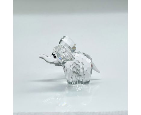 Clear faceted crystal figure of an elephant with black eyes and frosted tail. Part of the African Wildlife collection. Swarov