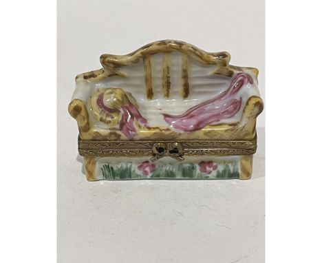 Limited Edition hand painted garden bench mini box. A garden hat and matching scarf lay atop the bench with flowers and green