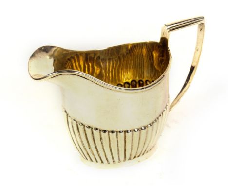 A George V silver cream jug, of semi fluted design, with a tapered reeded handle, Chester 1911, makers George Nathan &amp; Ri