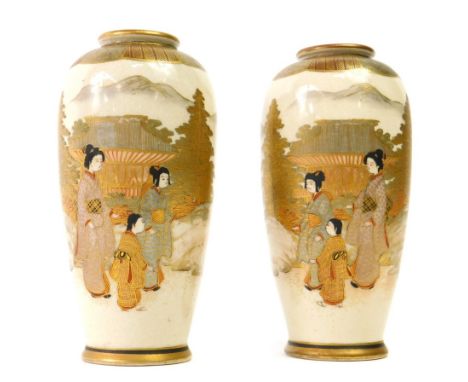 A pair of Meiji period Satsuma baluster vases, decorated with opposing figures in landscapes and lappet shoulders with gilt o