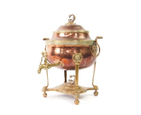 A George III copper and brass oval tea urn, with Egyptian mask heads to the ring handles, the domed cover with dolphin knop, 