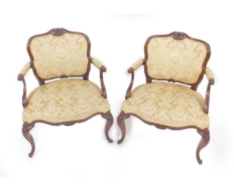 A pair of 18thC mahogany framed open armchairs, in the Chippendale manner and of French persuasion, with finely carved cresti